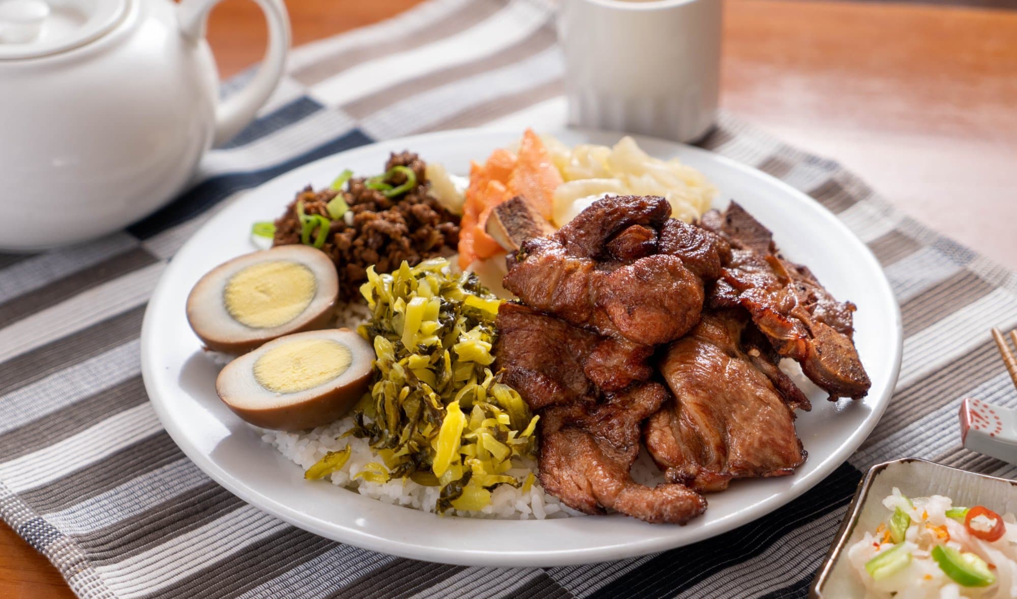 Pork Chop Rice Combination - This Bento Box includes tender and flavorful pork chops served over a bed of ste | Bento Box