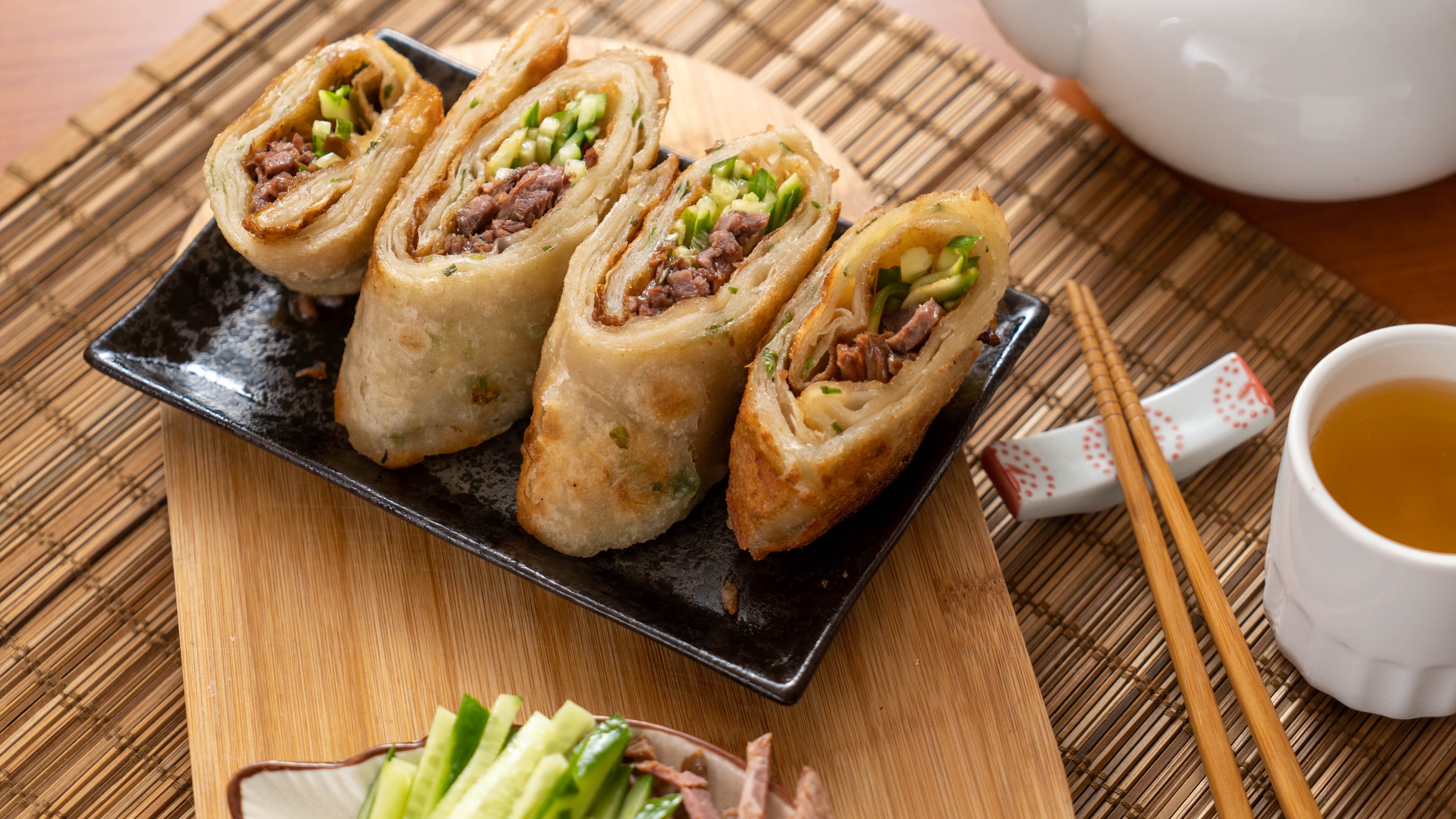Marinated Beef Pancake Roll - Thinly sliced marinated beef rolled in a green onion pancake with condiments. A | Dim Sum