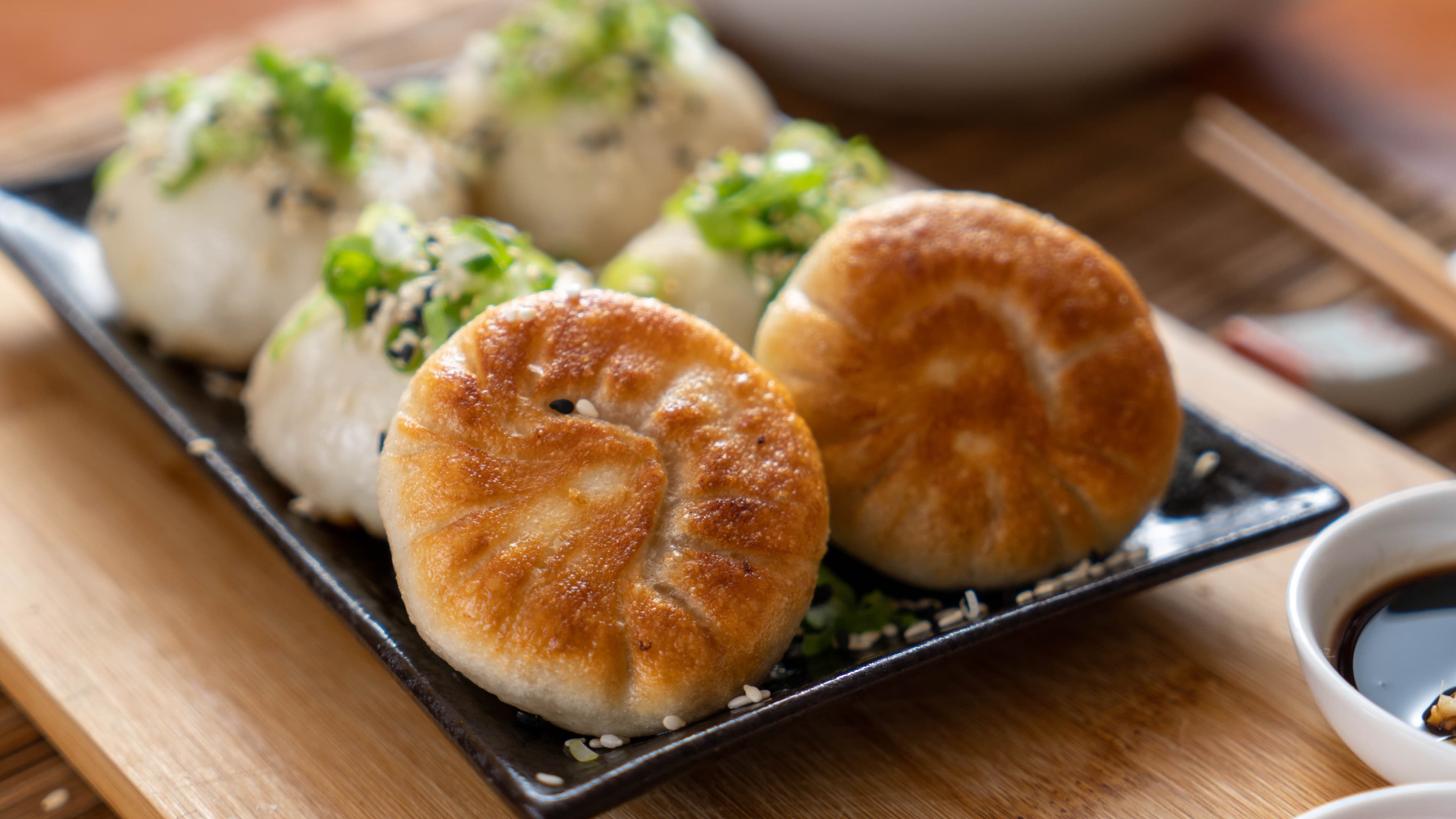 Shanghai Pork Pan Fried Soup Dumpling - Crispy-bottomed dumplings filled with flavorful pork and soup. A Shanghai favori | Dim Sum